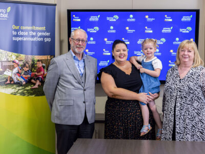 Group Photo Of Growing Potential's CEO Otto Henfling, Chair Of The Board Carol Vella, And Employee Relations Coordinator Ashleigh Bender With Her 3 Year Old Daughter Lola, Taken In A Boardroom